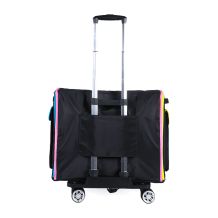 Back view of the Rolling Goat™ 2.0 showing the sleeve that secures onto the trolley handle, with pink, blue, and yellow side piping visible and 360° wheels at the base.